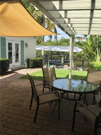a view of a patio with table and chairs and potted plants