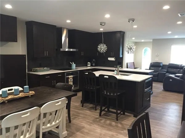 a kitchen with a sink appliances and cabinets