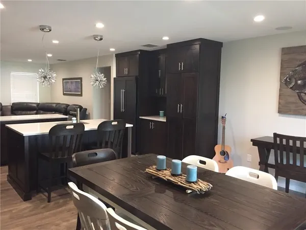 a kitchen with a table chairs and refrigerator