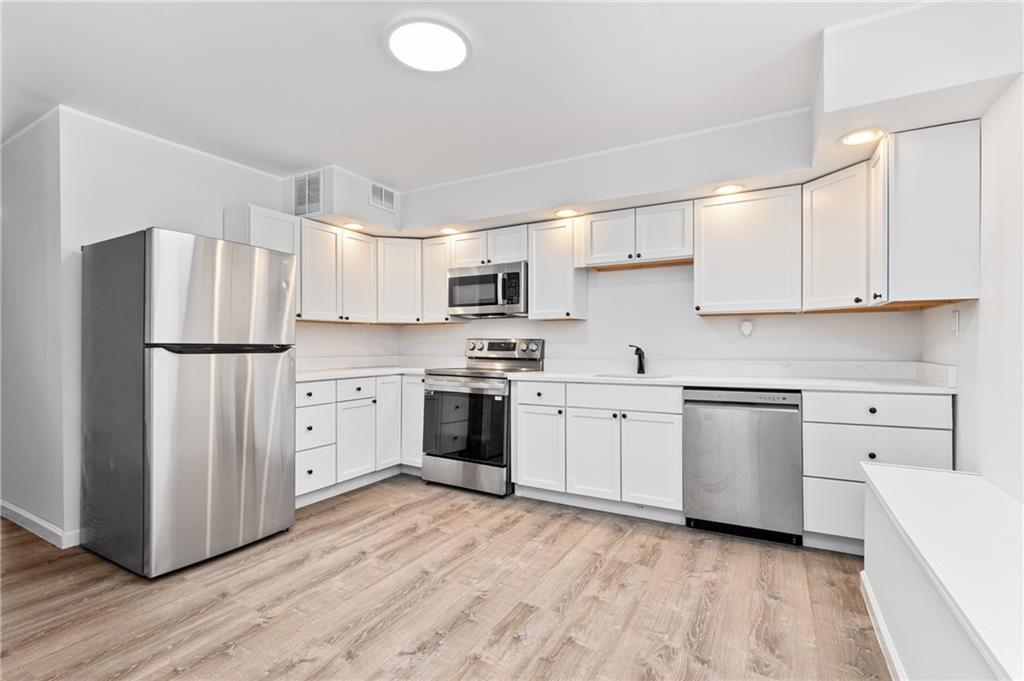 3005 Walton Road Finleyville, PA 15332 - Photo 11 of 31 a kitchen with white cabinets and stainless steel appliances