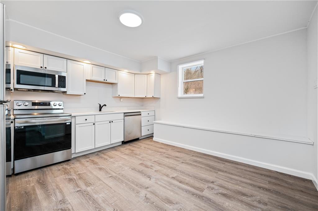3005 Walton Road Finleyville, PA 15332 - Photo 13 of 31 a kitchen with stainless steel appliances granite countertop a stove a sink and a microwave