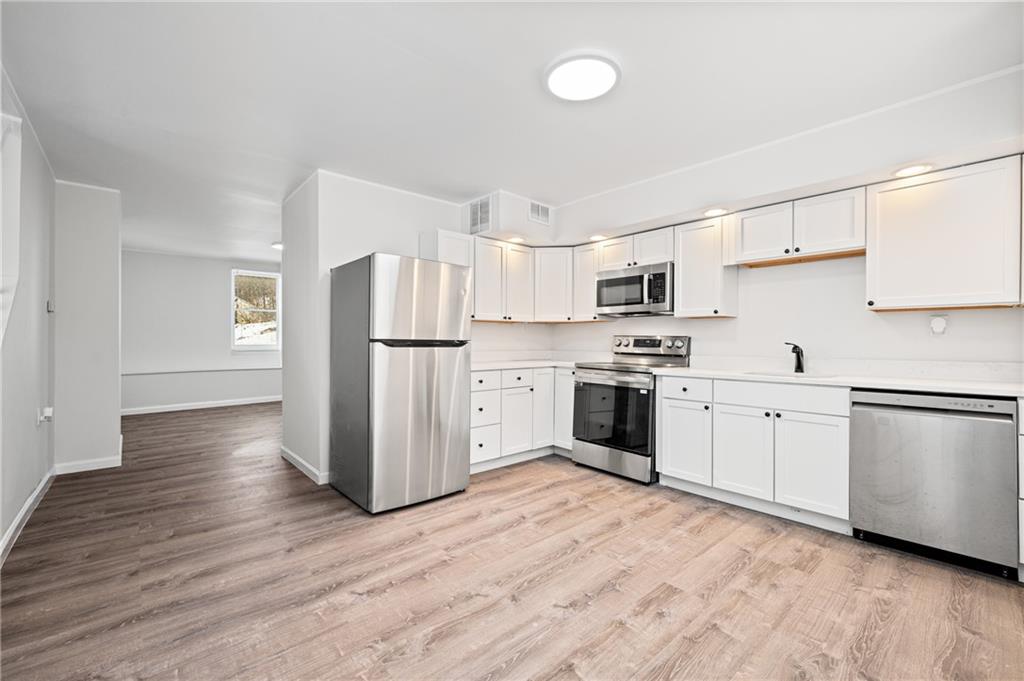3005 Walton Road Finleyville, PA 15332 - Photo 14 of 31 a kitchen with granite countertop white cabinets and stainless steel appliances