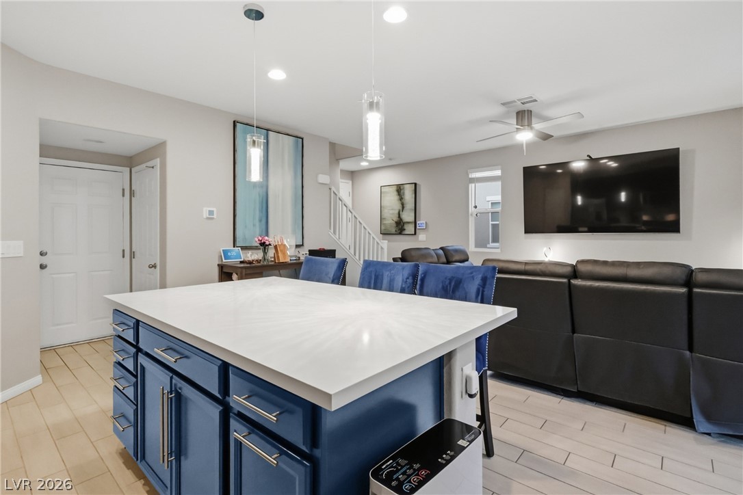 1921 Miller Ridge Avenue North Las Vegas, NV 89031 - Photo 8 of 26 This open concept living space features a kitchen island, perfect for entertaining guests.