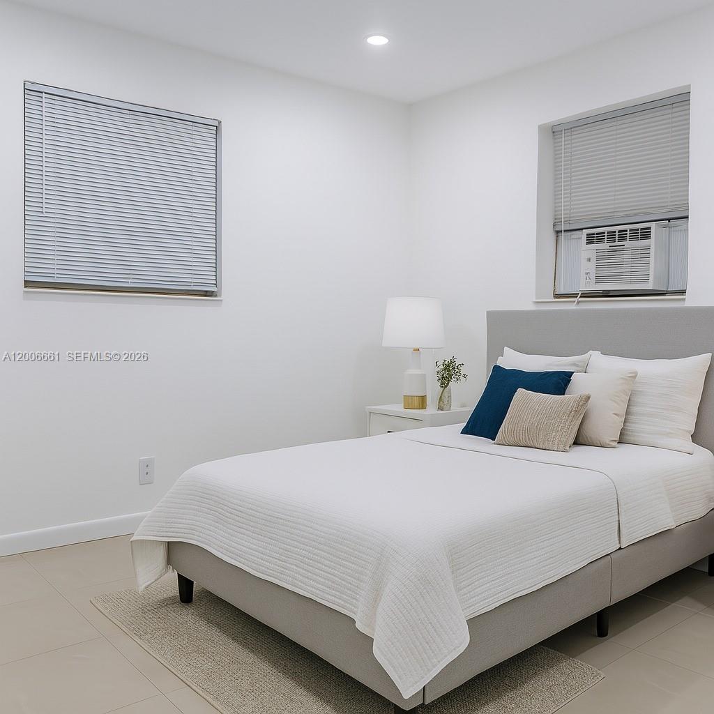 1046 Foster Road Hallandale Beach, FL 33009 - Photo 2 of 7 a bedroom with a bed and wall painting