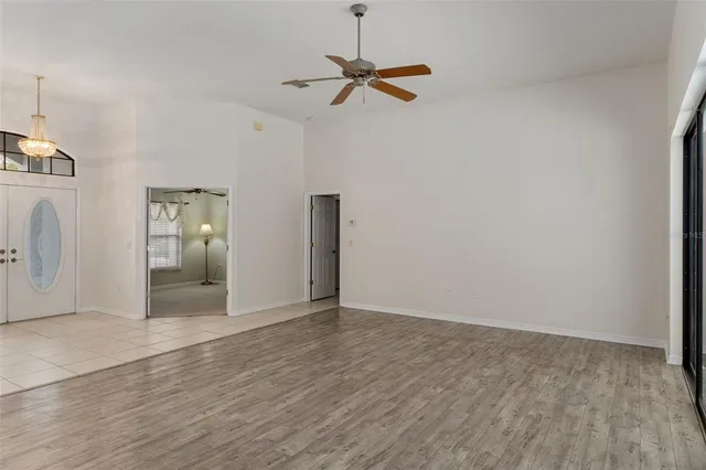 a view of a livingroom with wooden floor and a ceiling fan