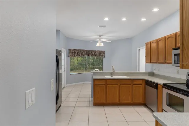a large kitchen with a sink and cabinets