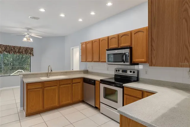 a kitchen that has a sink and a stove top oven