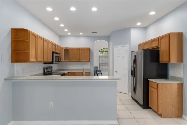 a kitchen with stainless steel appliances granite countertop a refrigerator and a sink