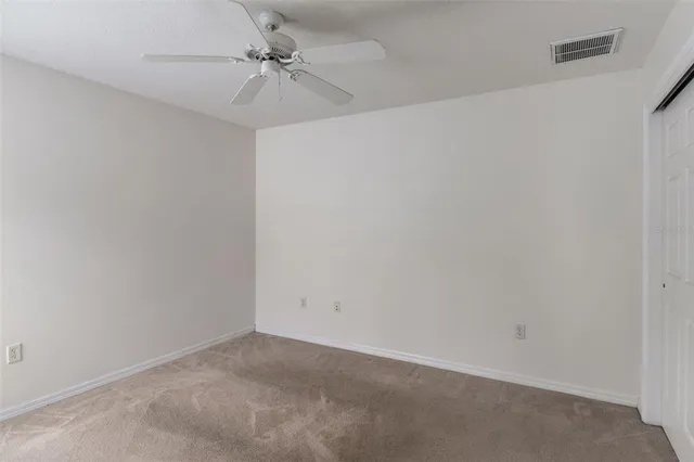 an empty room with windows and cabinet