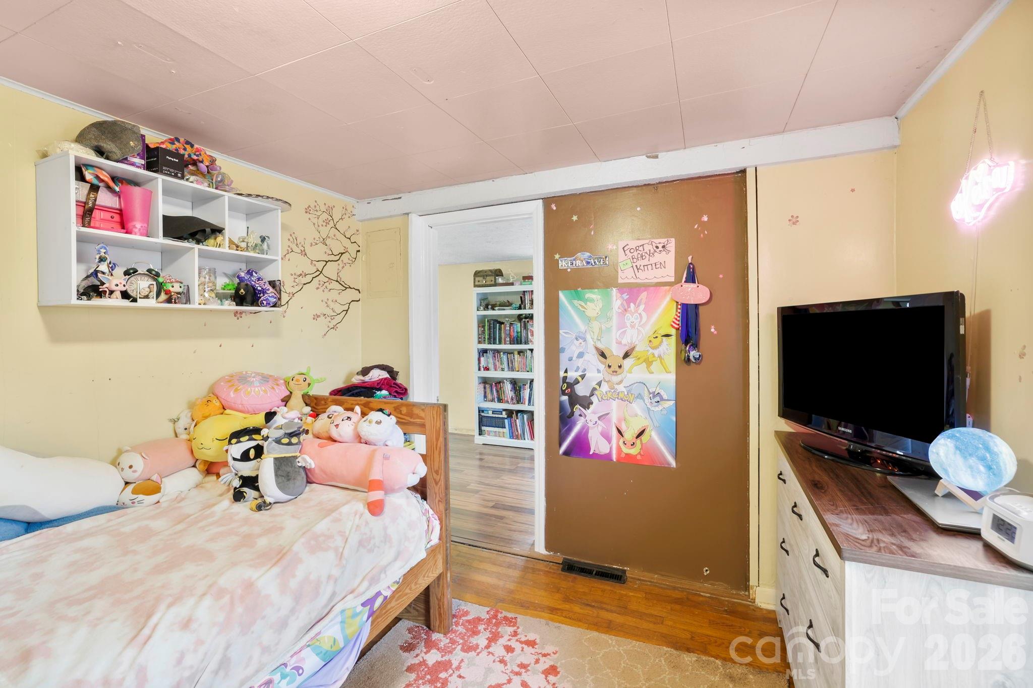 38 Pisgah View Road Asheville, NC 28806 - Photo 15 of 24 a bedroom with a bed and flat screen tv