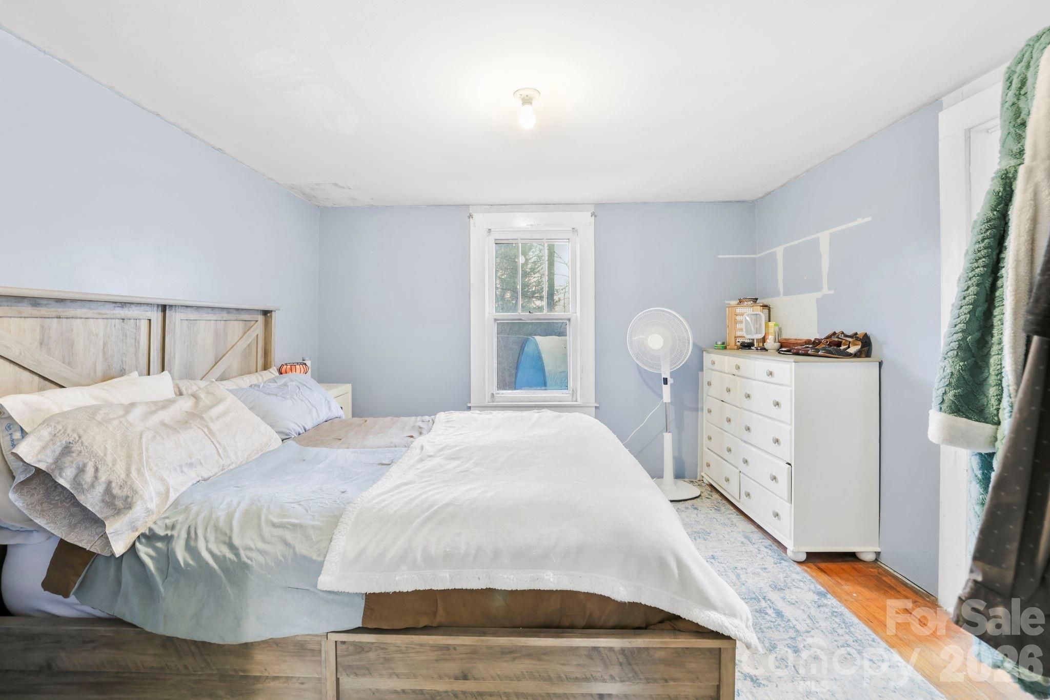 38 Pisgah View Road Asheville, NC 28806 - Photo 16 of 24 a bedroom with a bed and wooden floor