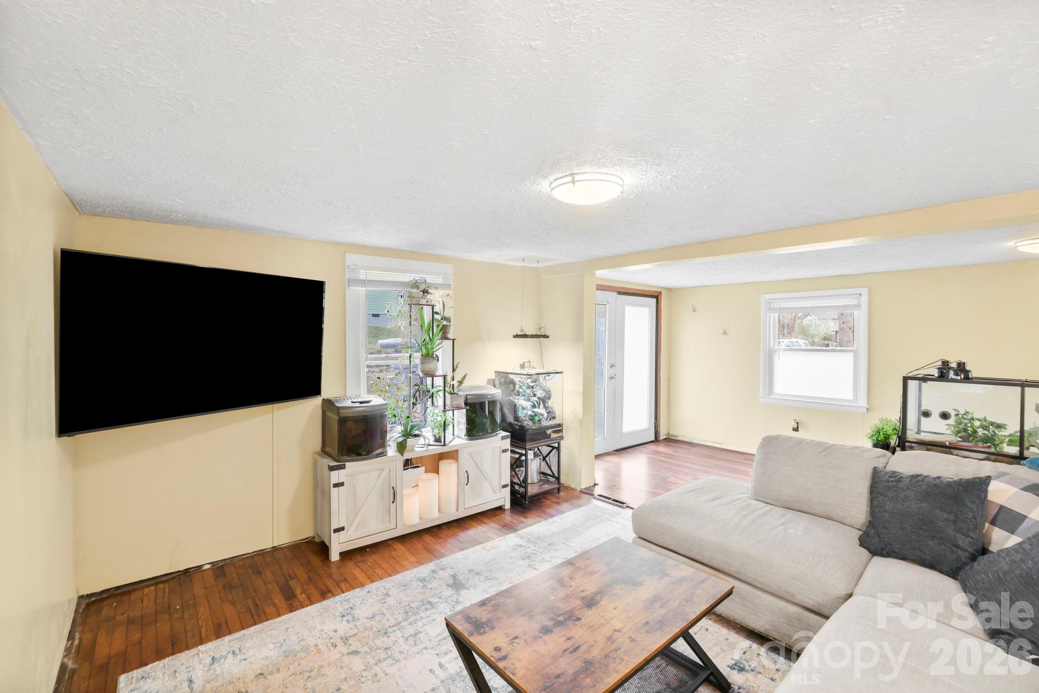 38 Pisgah View Road Asheville, NC 28806 - Photo 4 of 24 a living room with furniture and a flat screen tv