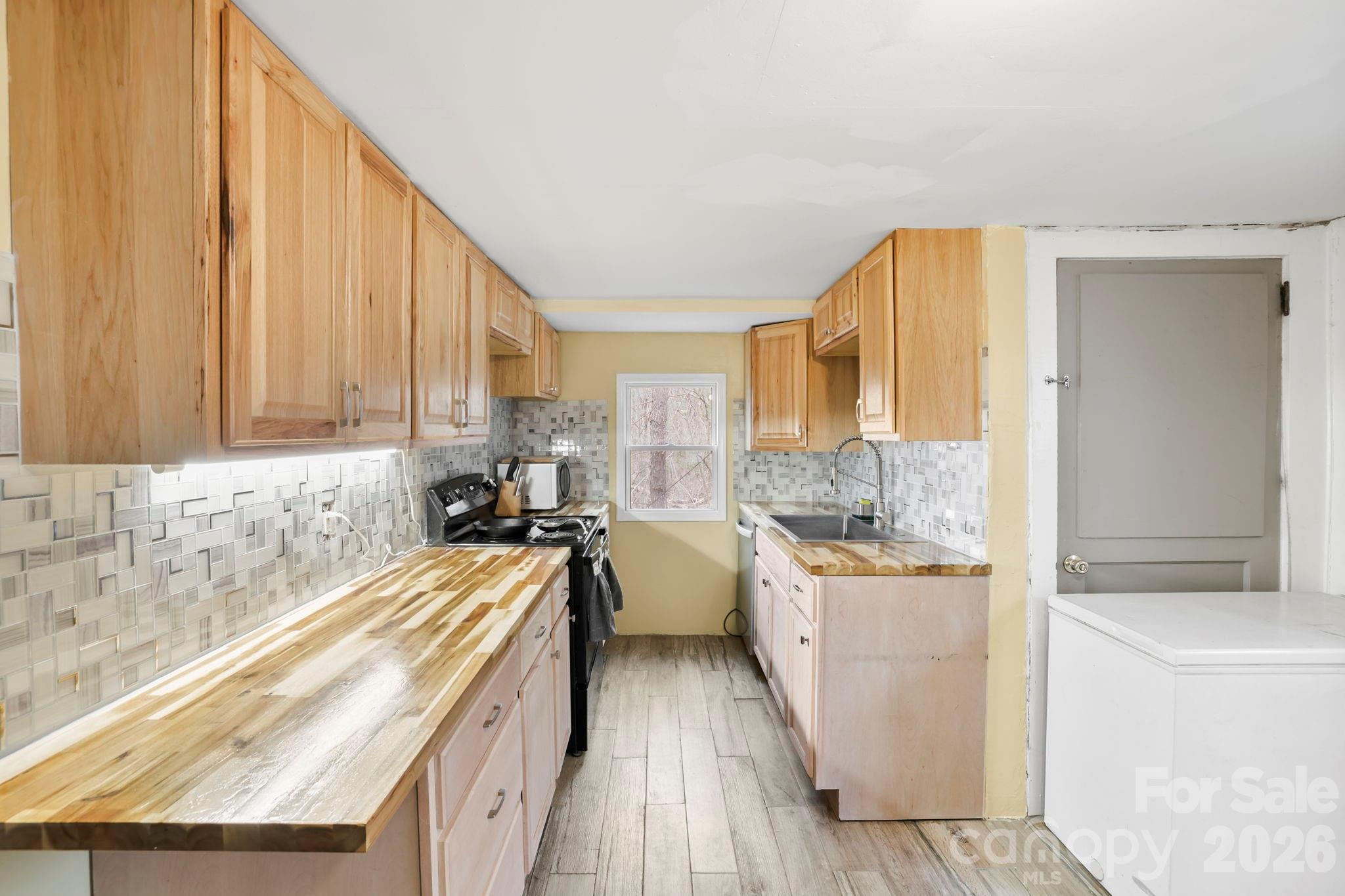 38 Pisgah View Road Asheville, NC 28806 - Photo 9 of 24 a view of a kitchen with sink and dishwasher