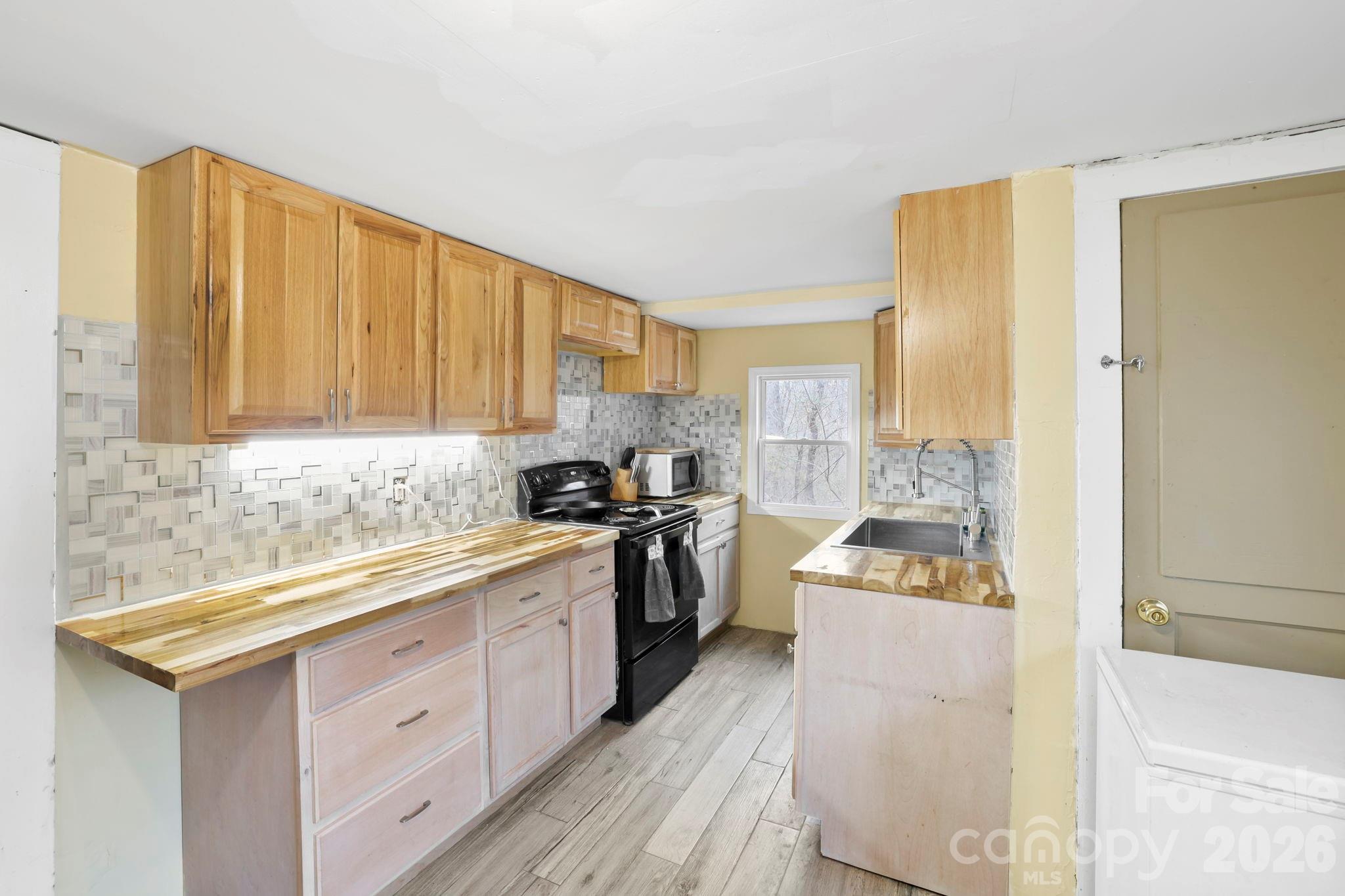 38 Pisgah View Road Asheville, NC 28806 - Photo 10 of 24 a kitchen with a sink stove and refrigerator