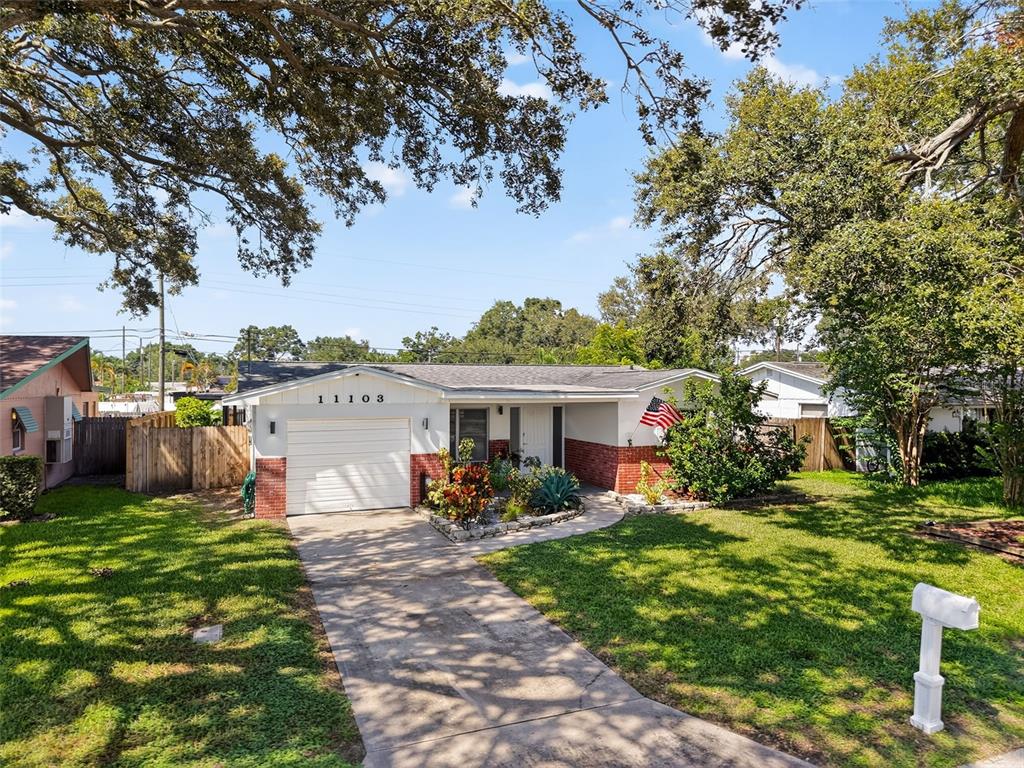 a view of a house with backyard sitting area and garden