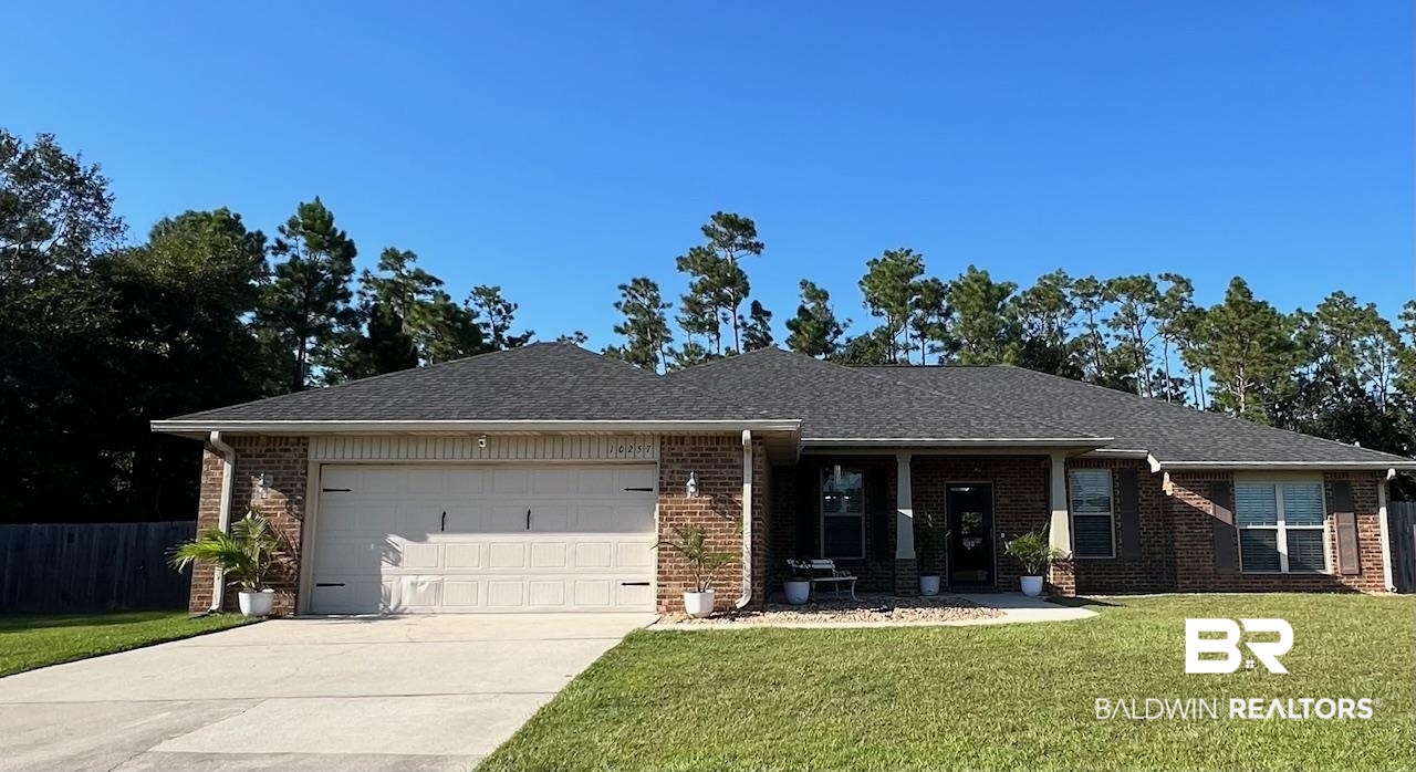 10257 Lyttleton Loop Lillian, AL 36549 - Photo 1 of 31 View of front of house with brick siding, covered porch, an attached garage, concrete driveway, and roof with shingles