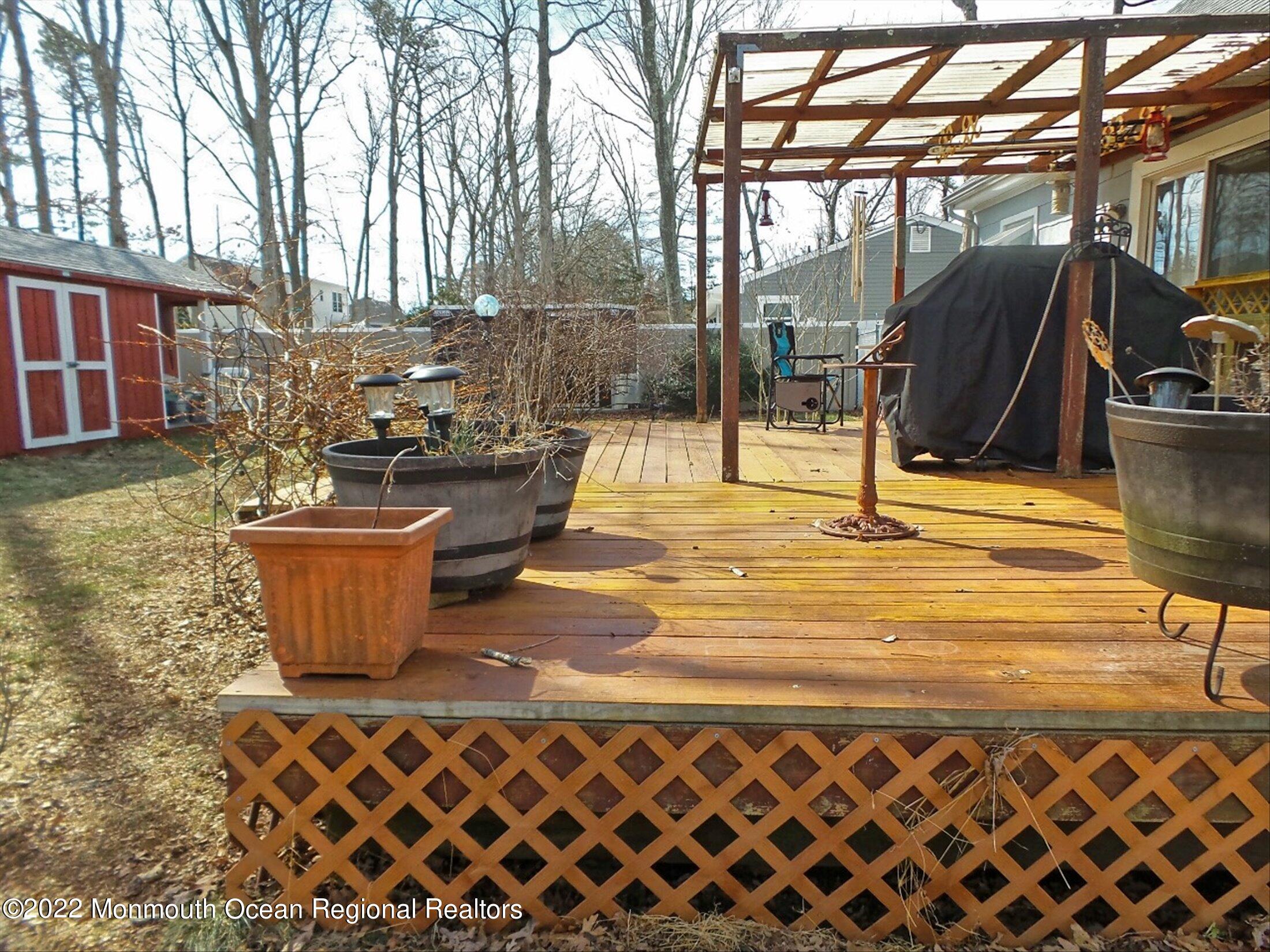 156 Topside Road Manahawkin, NJ 08050 - Photo 17 of 19 a view of a patio with table and chairs and potted plants