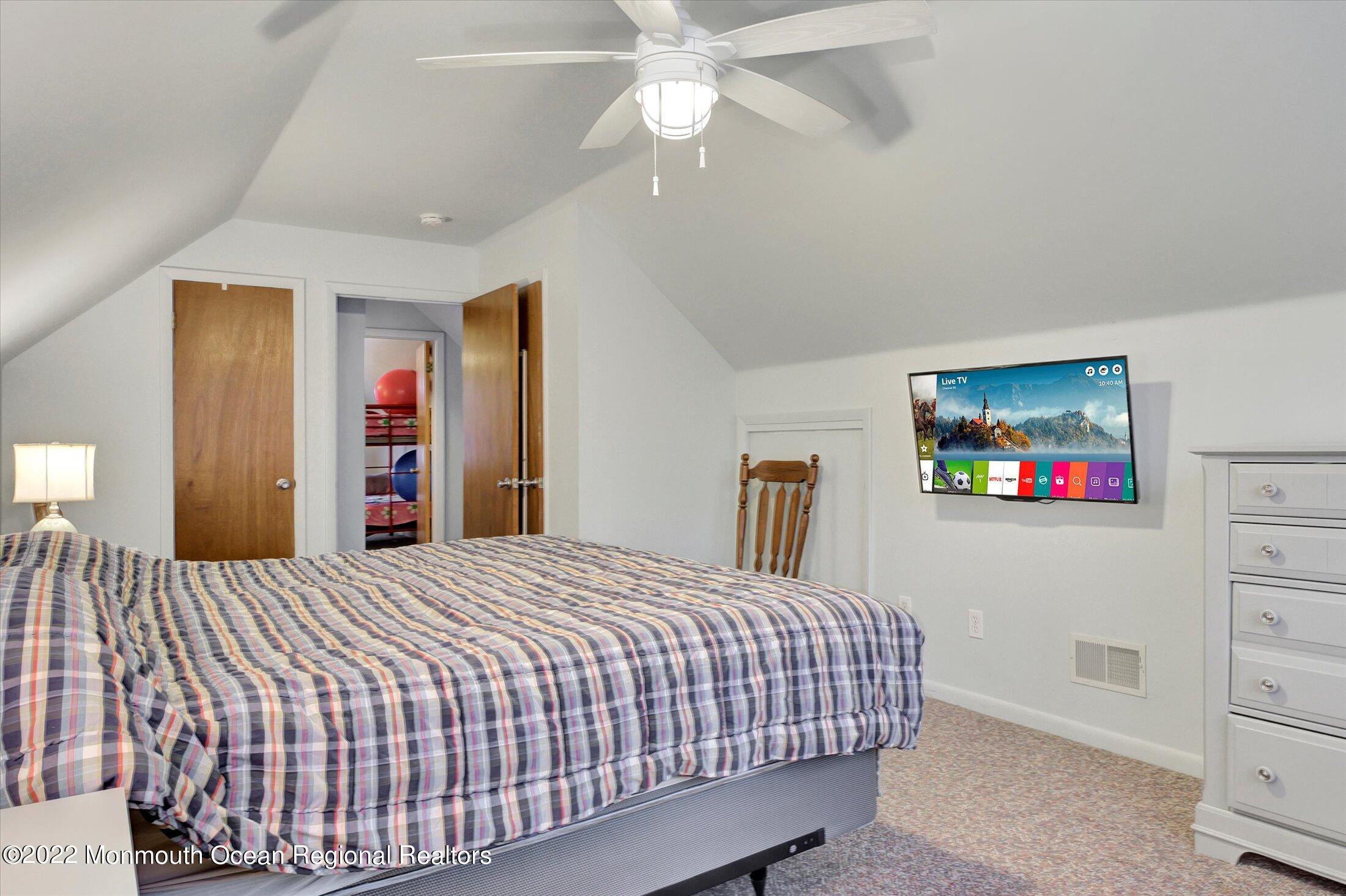 156 Topside Road Manahawkin, NJ 08050 - Photo 9 of 19 a bedroom with a bed and a flat screen tv