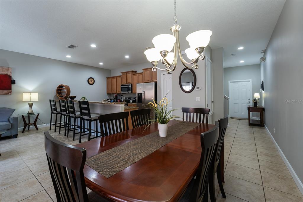 8957 Cat Palm Road Kissimmee, FL 34747 - Photo 12 of 25 a view of a dining room and hall with furniture
