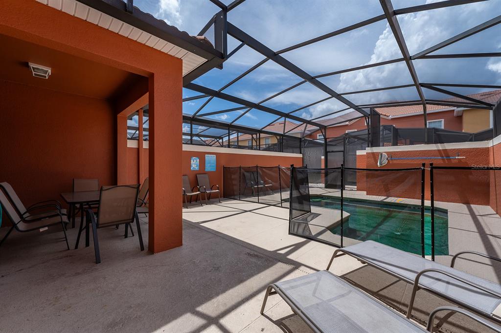 8957 Cat Palm Road Kissimmee, FL 34747 - Photo 13 of 25 a view of a patio with table and chairs potted plants with wooden floor