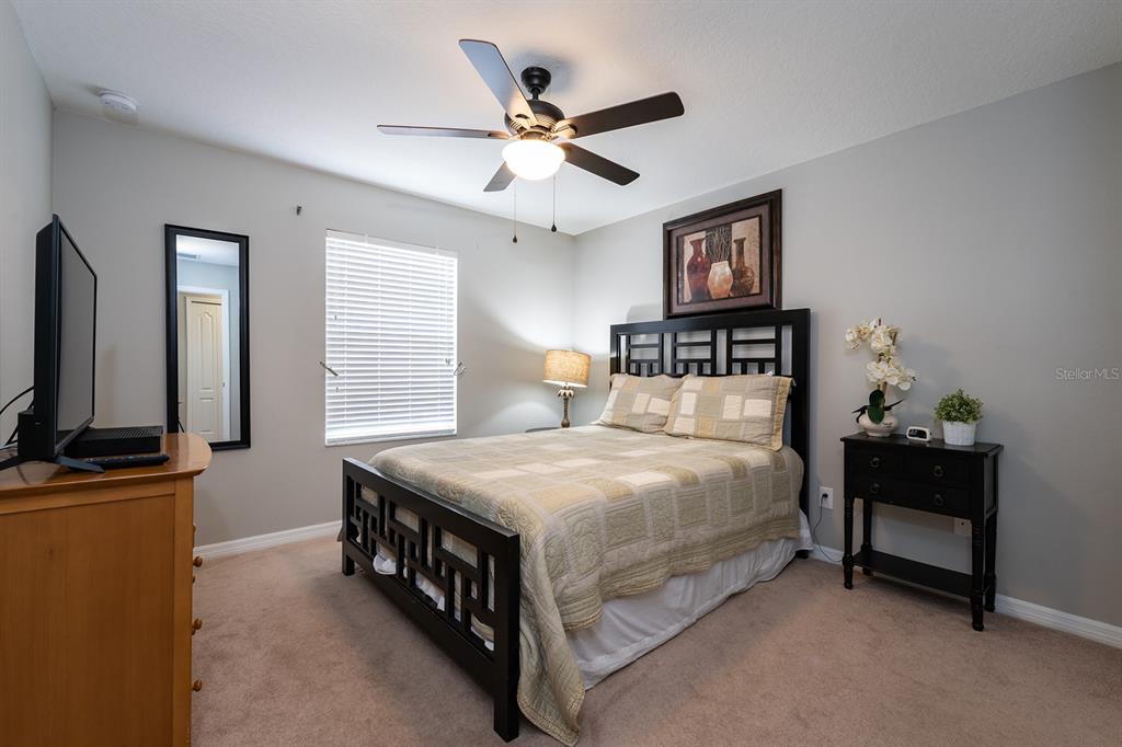 8957 Cat Palm Road Kissimmee, FL 34747 - Photo 20 of 25 a bedroom with a bed and a flat screen tv