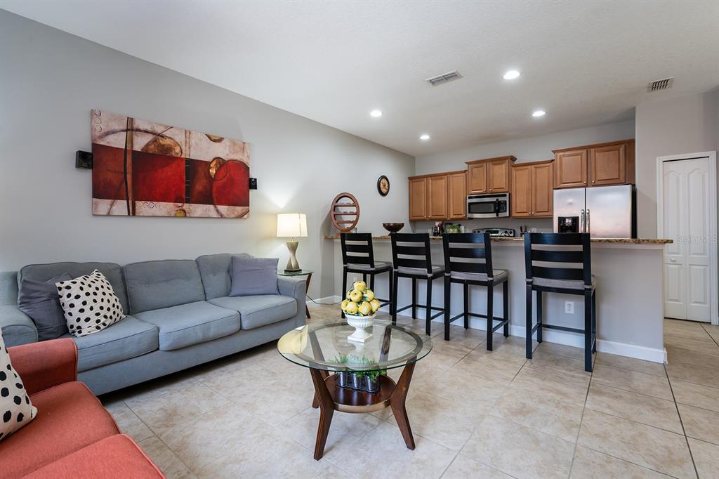 8957 Cat Palm Road Kissimmee, FL 34747 - Photo 7 of 25 a living room with furniture and kitchen view