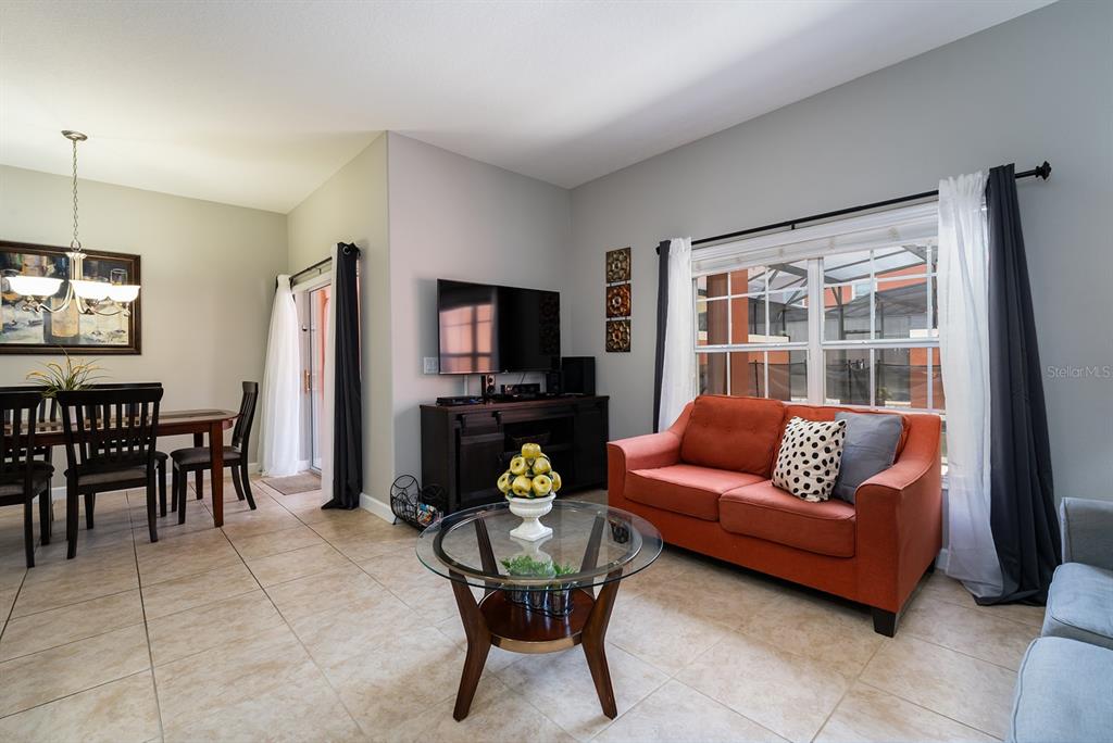 8957 Cat Palm Road Kissimmee, FL 34747 - Photo 9 of 25 a living room with furniture and a flat screen tv