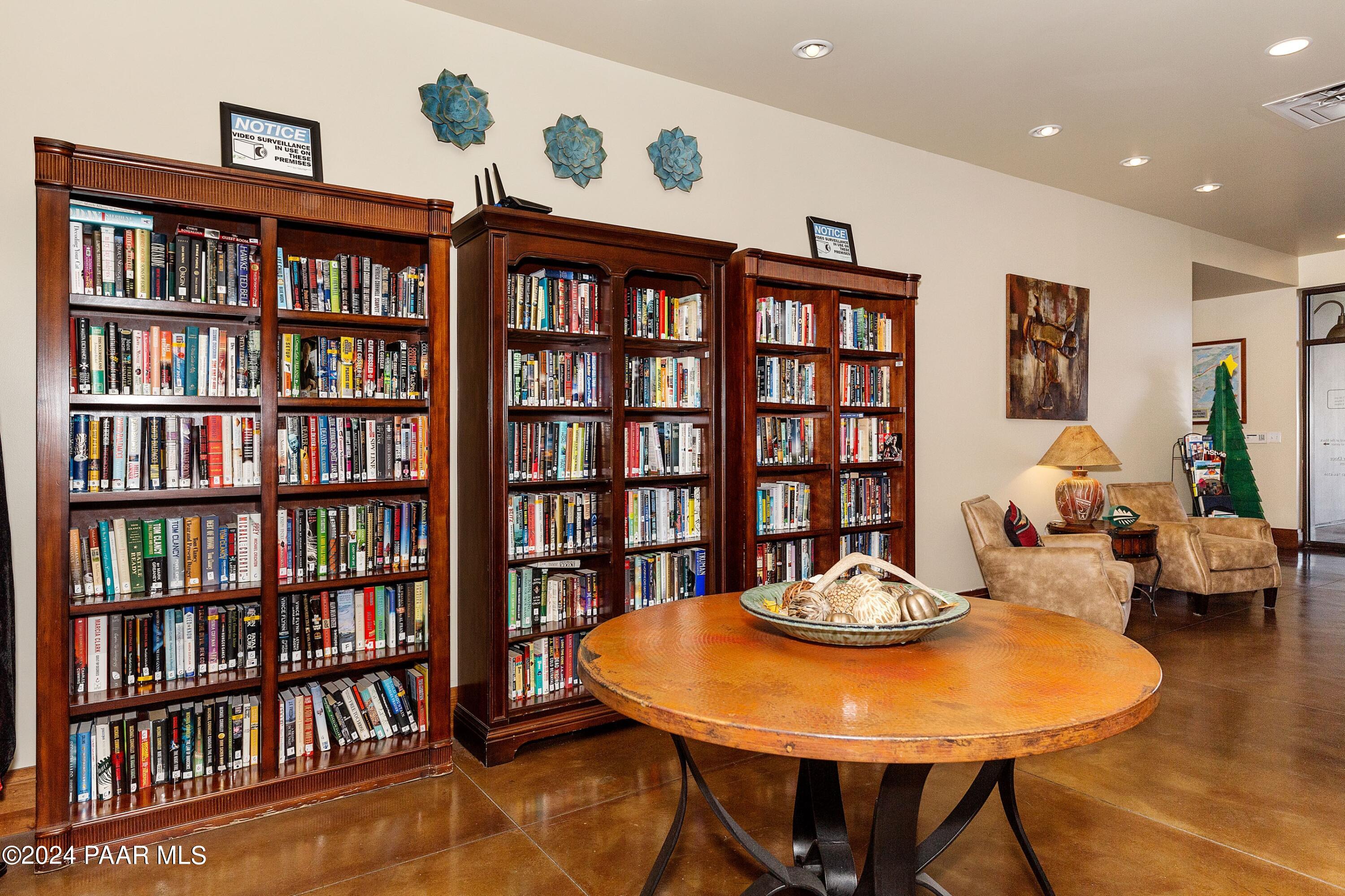 1195 Rigo Ranch Road Prescott Valley, AZ 86314 - Photo 27 of 65 a living room with furniture and a book shelf