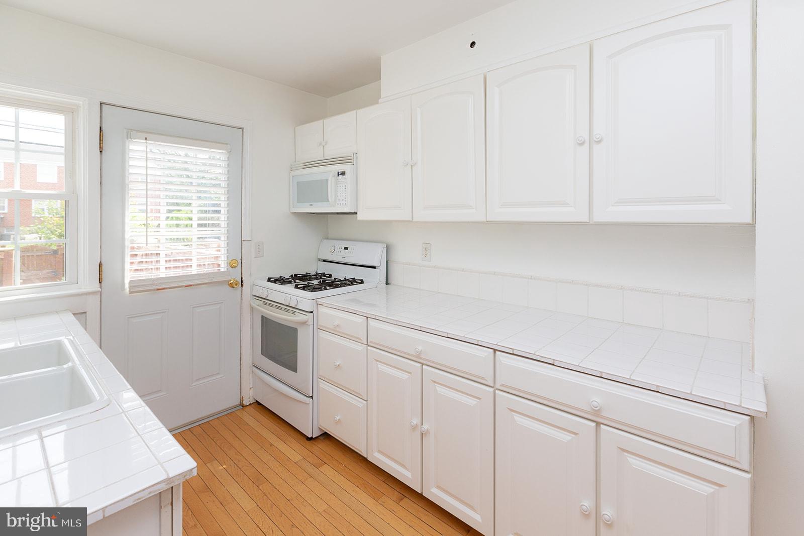8133 Pleasant Plains Road Baltimore, MD 21286 - Photo 6 of 18 Bright white kitchen!
