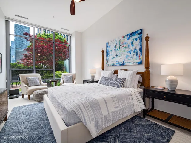 a bedroom with a large bed and a window