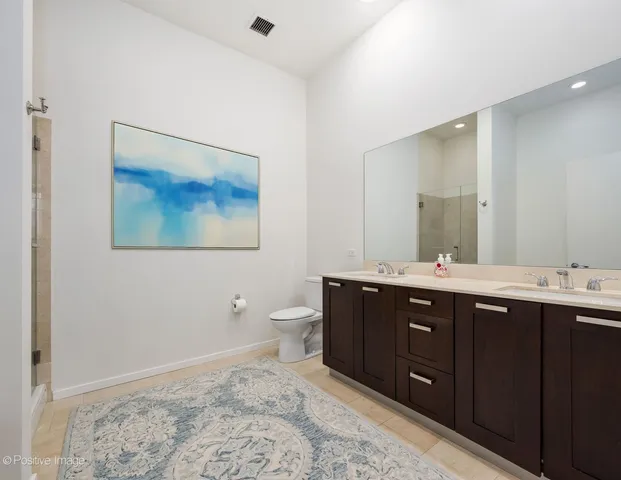 a spacious bathroom with a toilet sink and mirror