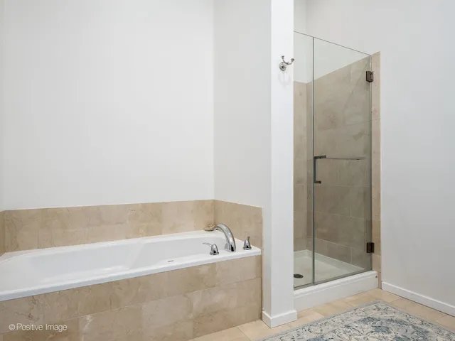 a bathroom with a bathtub and shower