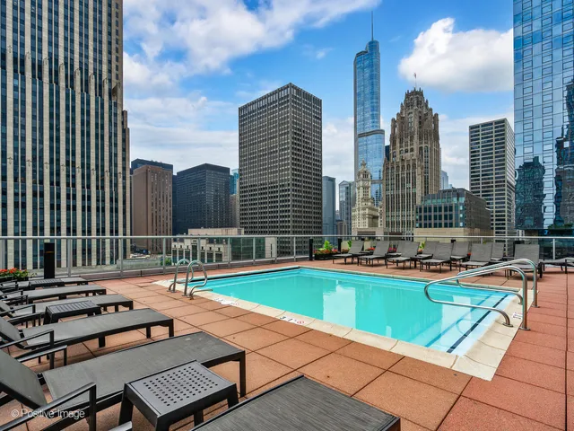 a swimming pool with outdoor seating and yard