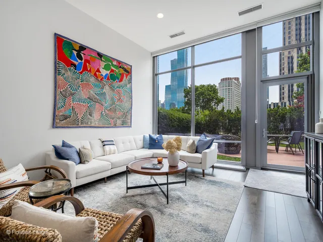 a living room with furniture and a large window with outer view