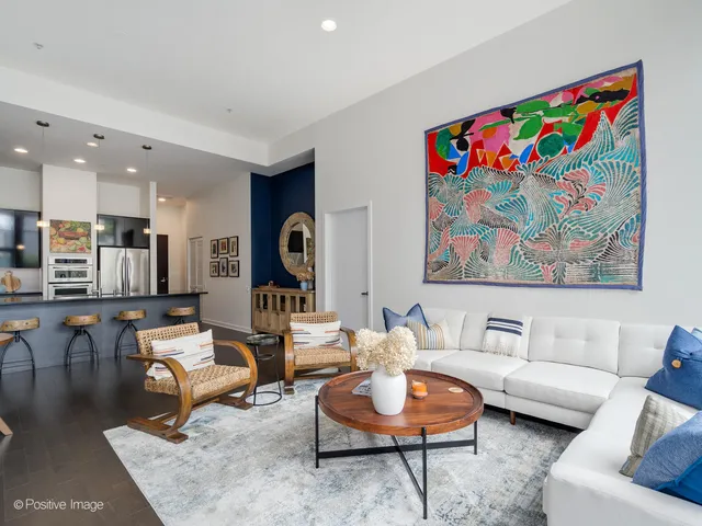 a living room with furniture and kitchen view