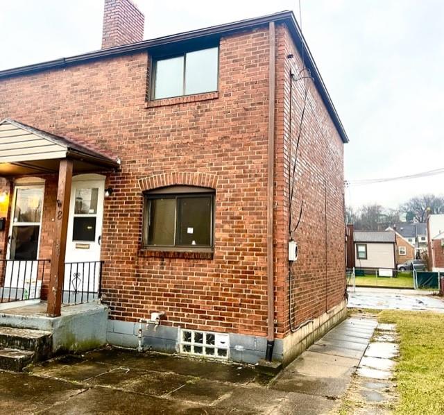 a view of a brick house with many windows