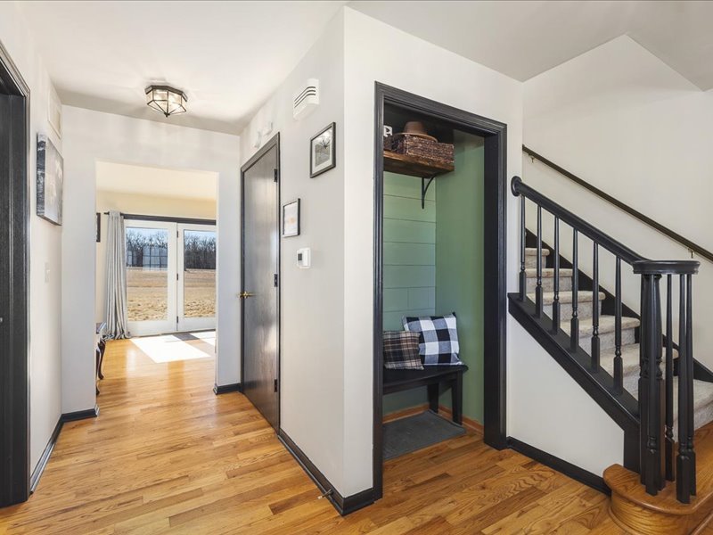 911.41 Melugins Compton, IL 61318 - Photo 11 of 67 a view of a hallway to a livingroom with wooden floor and furniture