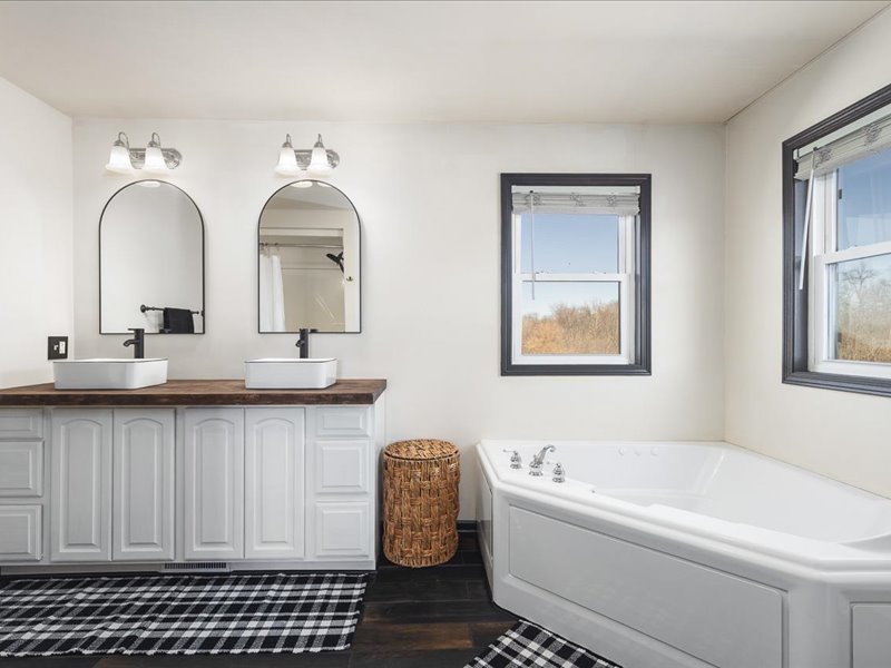 911.41 Melugins Compton, IL 61318 - Photo 34 of 67 a bathroom with a double vanity sink a mirror and a bathtub