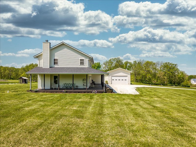911.41 Melugins Compton, IL 61318 - Photo 54 of 67 a view of a house with a big yard and large trees