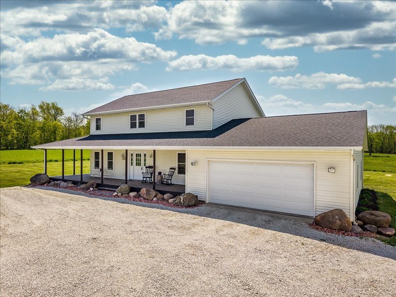 911.41 Melugins Compton, IL 61318 - Photo 8 of 67 a front view of a house with a yard and sitting area