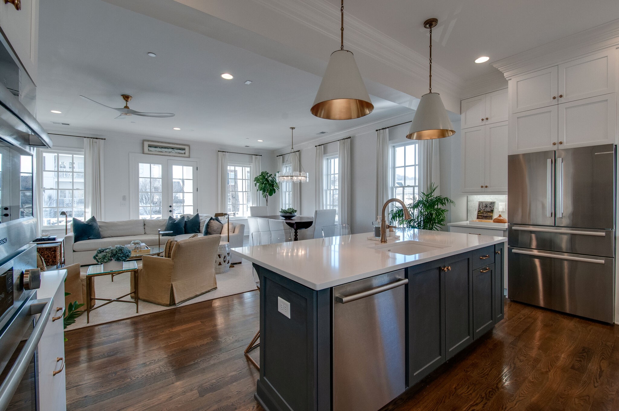 101 Front Street Franklin, TN 37064 - Photo 21 of 50 a kitchen with stainless steel appliances granite countertop a stove a refrigerator a kitchen island a dining table and chairs with wooden floor