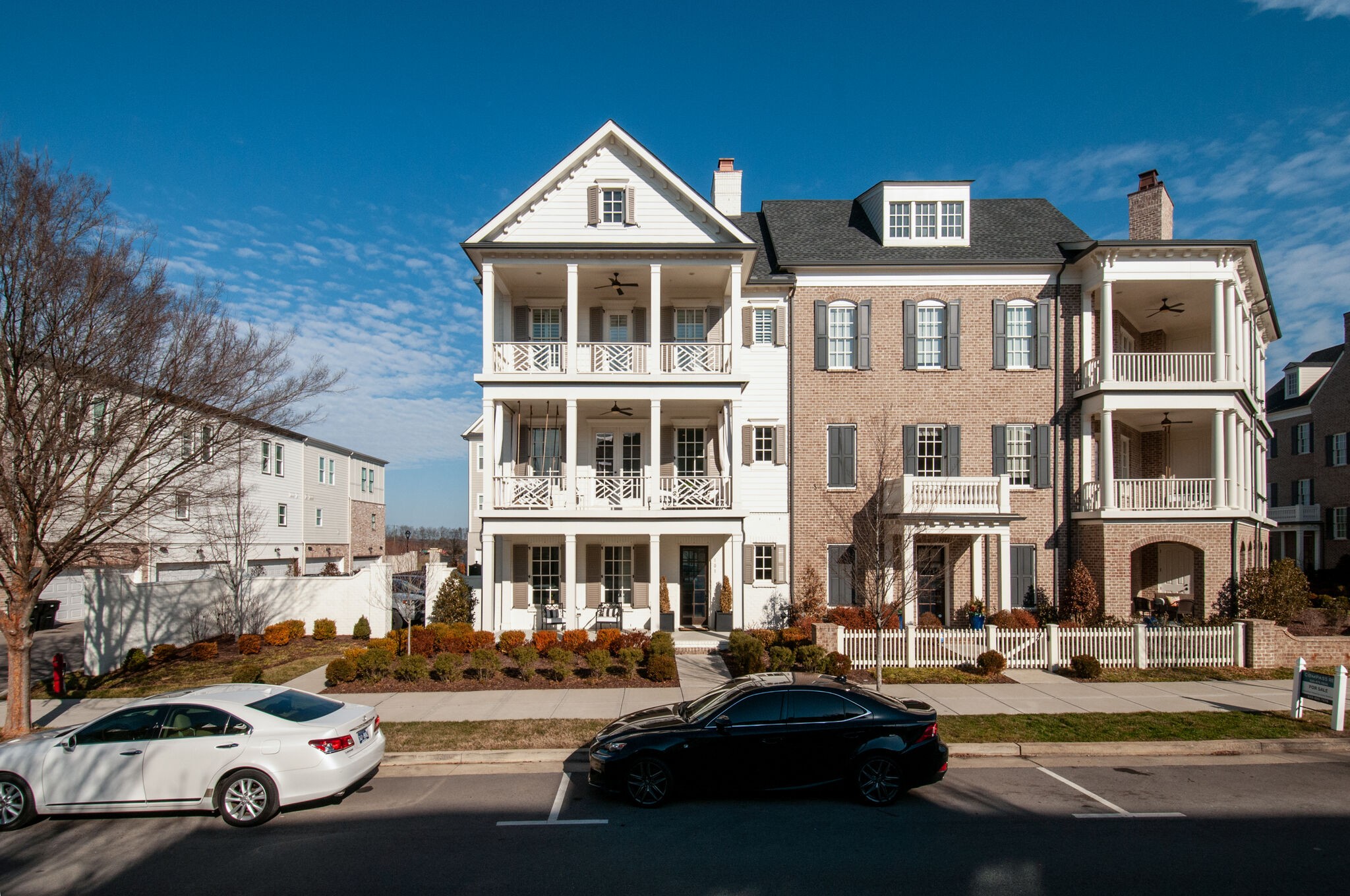 101 Front Street Franklin, TN 37064 - Photo 3 of 50 a front view of a building with lot of cars and trees