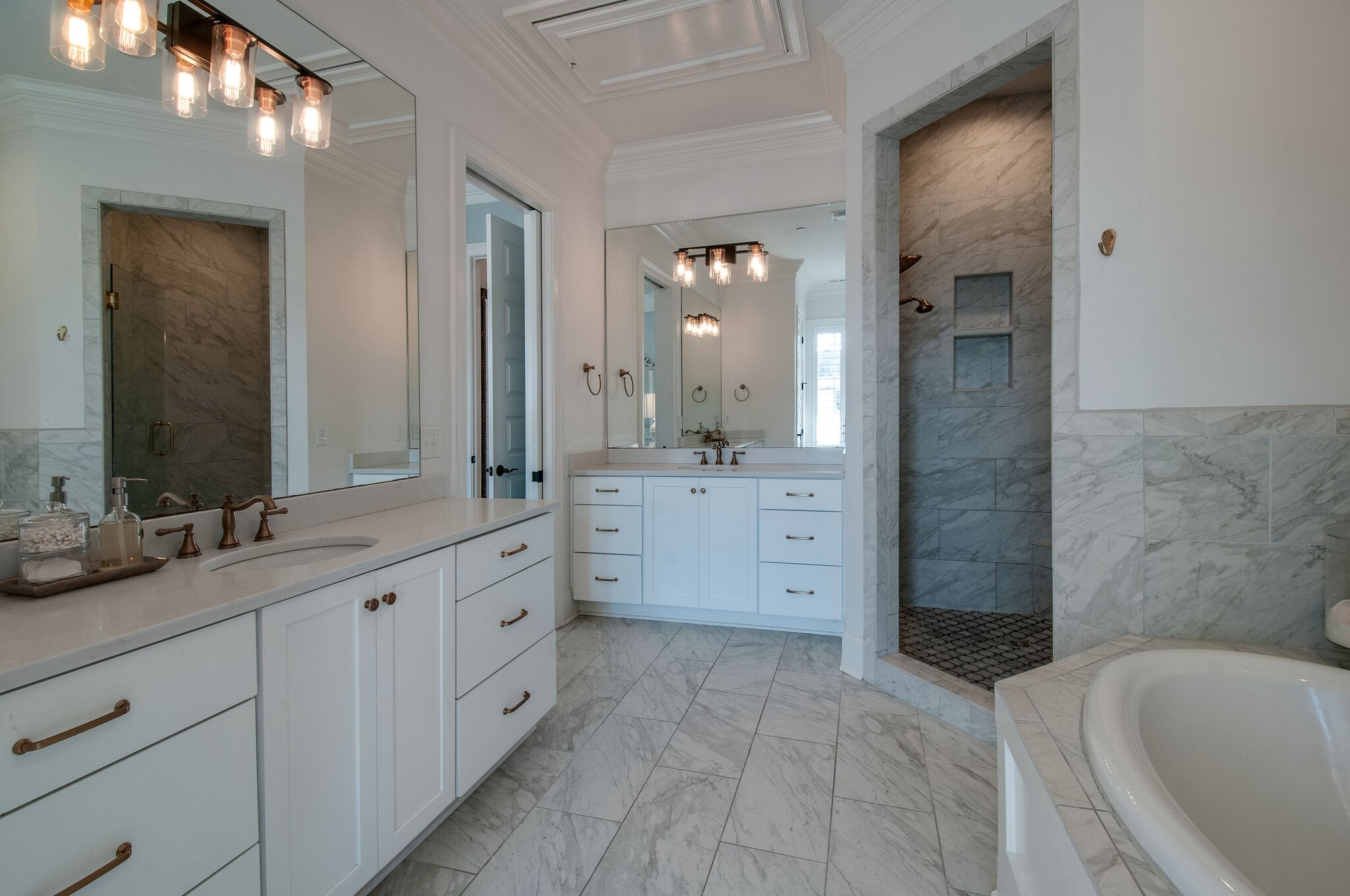 101 Front Street Franklin, TN 37064 - Photo 38 of 50 a spacious bathroom with a double vanity sink a mirror and a bathtub