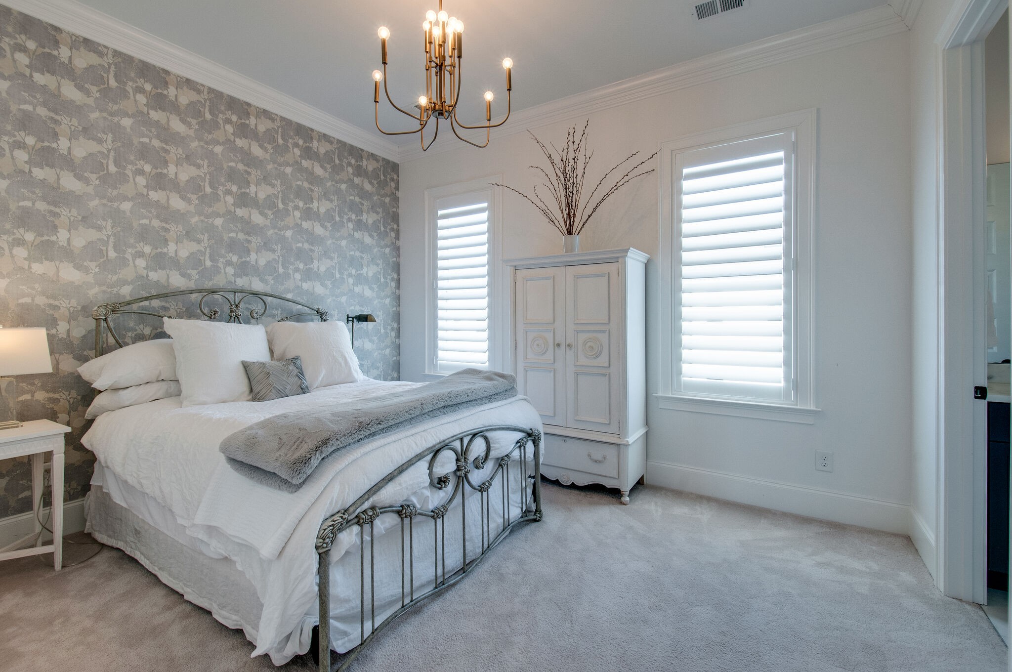 101 Front Street Franklin, TN 37064 - Photo 39 of 50 a spacious bedroom with a bed and a chandelier