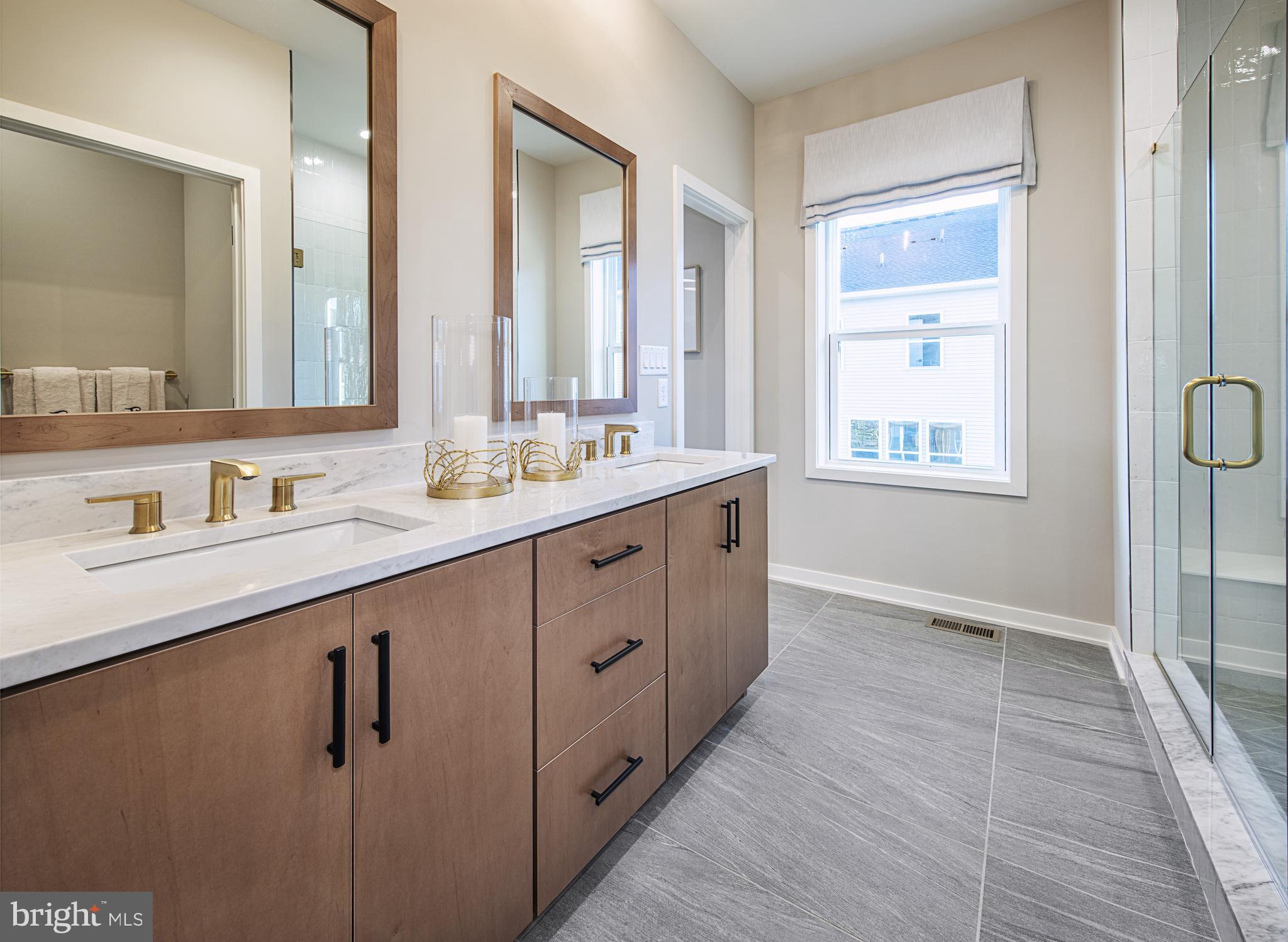 606 Kemlyn Road, Unit HOMESITE 184 Malvern, PA 19355 - Photo 14 of 15 a spacious bathroom with a double vanity sink a mirror and a