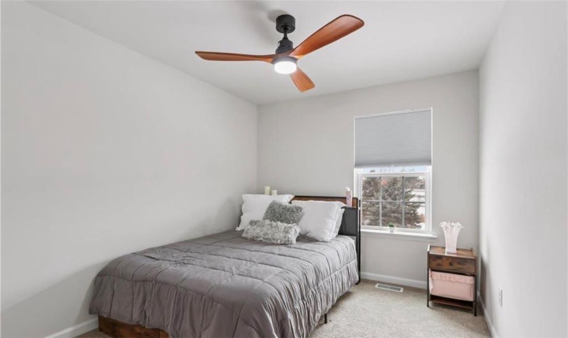 1138 Martin Road Breinigsville, PA 18031 - Photo 6 of 9 A well-lit bedroom features a contemporary ceiling fan and views of the surrounding landscape.