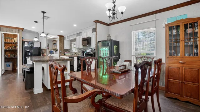 a view of a dining room with furniture and window