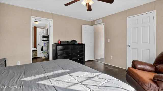 a bedroom with a bed and ceiling fan
