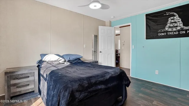 a bedroom with a bed and a painting on the wall