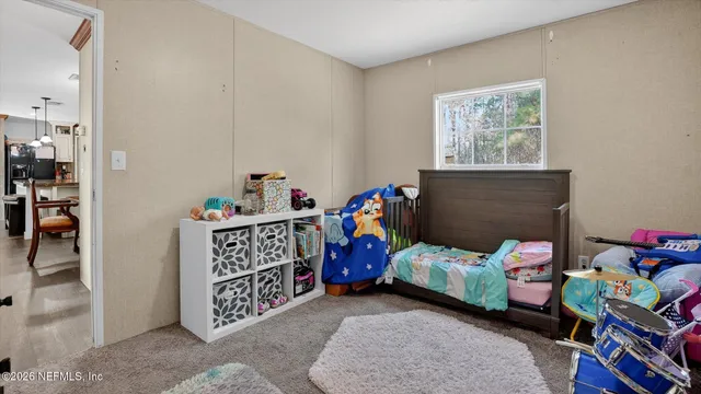 a bedroom with two beds and a window